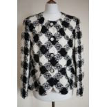 A lady's Rena Lange peplum jacket manufactured with Linton Tweed fabric, in a black and white