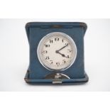 An early 20th Century blue leather cased travelling bedside clock