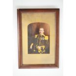 A hand-coloured photograph of a Victorian Naval officer, framed and mounted under glass, 29 x 20 cm