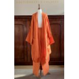 A Shirin Guild burnt orange linen freeform jacket and trouser suit, the jacket in a size S, the