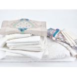 A quantity of antique linens, including a whitework embroidered table cloth, embroidered table