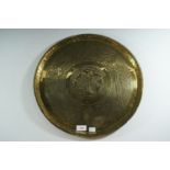 A brass wall plaque, 35cm diameter
