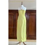 A 1960s Nettie Vogues lemon-yellow linen evening dress, with yellow piping to the neckline,