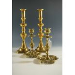 A pair of Victorian brass push-eject candlesticks together with an ornate cast pair, 30 cm and 17