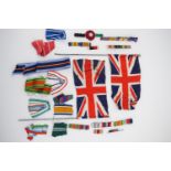 A quantity of military medal ribbon bars, ribbons and two Union flags / pennants