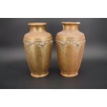 A pair of early 20th Century brass vases, 27 cm