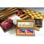 A backgammon set, boxed playing cards, chess board etc