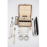 A cased set of electroplate teaspoons, two pairs of sugar tongs, three pickle forks, a cased