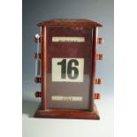 A vintage mahogany desk calendar