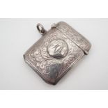 A George V silver vesta case, profusely foliate engraved surrounding a cartouche, Birmingham,