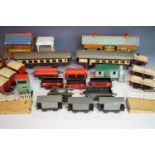A large quantity of O-gauge model railway carriages, rolling stock, station buildings, track and