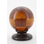 A 19th Century spherical wooden novelty money box, 12 cm