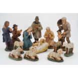 A fine painted plaster nativity scene, thirteen figures, tallest approximately 15 cm, late 19th /