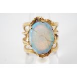 A contemporary high carat yellow metal and opal statement ring, of organic design, having a