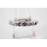 A contemporary diamond and platinum eternity ring, of wheel form, the face illusion set with various