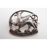 An Alexander Ritchie Iona Scottish white metal 'MacKinnon' bonnet badge / brooch, depicting a