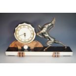 A French Art Deco marble figural mantle clock, with a bronze-patinated cast copper leaping
