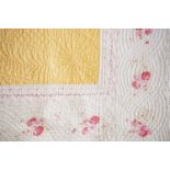 An antique Durham quilt, in egg-yolk yellow and pink florally printed cotton, 226 x 400, late 19th /