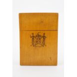 A 19th Century Mauchline Ware playing cards box, decorated with a penwork family crest to one