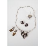 A contemporary white metal demi parure comprising Nikos necklace, matched ring, ear clips and