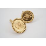 A gentleman's pair of 18ct gold cuff links, of circular section with rope twist frame, the face