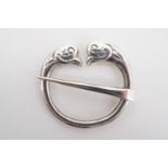 An Alexander Ritchie Iona Scottish silver penannular brooch, each terminal modelled as the head of a