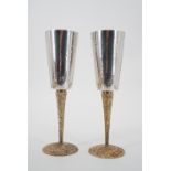 Stuart Devlin A pair of Elizabeth II silver champagne flutes, each with a tapering cylindrical bowl,