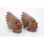 Two early 20th Century Canadian carved wooden pipe bowls each modelled as the head of a Native