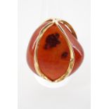 A contemporary high carat yellow metal and carnelian pebble cocktail ring, the carnelian of