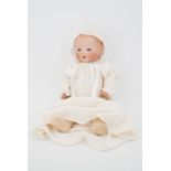 An Armand Marseille bisque headed baby doll, with fixed blue glass eyes and open mouth, with