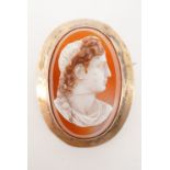 A Victorian agate cameo brooch, bearing the applied profile of a Roman gentleman, in gilt white-