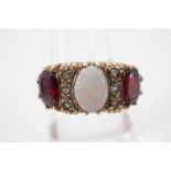 An impressive opal and garnet dress ring, having a central opal cabochon of approximately .78ct,