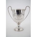 A silver trophy cup bearing the engraved inscription "Grafton Puppy Show, 1921, 2nd Prize won by