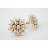 A pair of yellow metal and seed pearl stud earrings, in a flower head cluster arrangement,