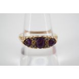 An 18ct gold, diamond and amethyst dress ring, the lenticular face sunken set with an oval-cut