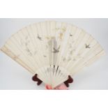 A Belle Epoque bone hand fan with painted gauze leaf, the latter decorated with bluebirds and