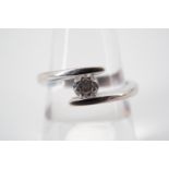 A contemporary diamond solitaire ring, of approximately .25ct, the brilliant-cut diamond held in a