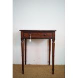 A George III mahogany writing desk, the top enclosing a writing surface and stationary compartments,