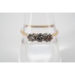 A vintage three-stone brilliant-cut diamond ring, each of approximately .10ct, pellet-set on a