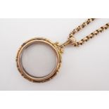 An antique rose yellow metal open-faced locket on belcher link neck chain, both stamped '9ct', chain