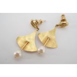 A pair of contemporary pearl ear pendants of geometric design, having a 'gold nugget' ear stud, with