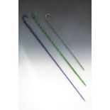 Three Victorian glass walking canes, in cobalt blue, emerald green and clear glass, the latter