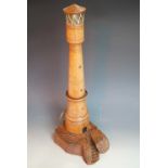 A vintage novelty table lamp modelled as a lighthouse, of turned and carved wood, 72 cm high