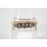 A five-stone diamond ring, the central diamond of approximately .25ct, pellet-set above a