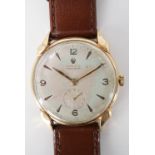 A 1950s Rolex 9ct gold wrist watch, having a precision manual-wind movement and frosted silver