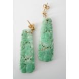 A pair of carved jade ear pendants, dependent beneath yellow metal ear studs, each drop of
