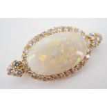 An impressive high-carat yellow-metal, diamond and opal pendant brooch, the central oval cabochon of