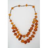 A vintage Latvian amber necklace, with two strands of graded polished beads, on a base metal