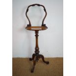 A Victorian walnut tripod screen with shelf, 110 cm