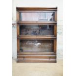 A Globe Wernicke four-section oak bookcase, the lower stage being a base with drawer